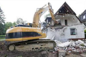 home being demolished by bulldozer