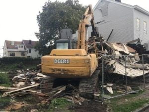 machine cleaning up a building demolition