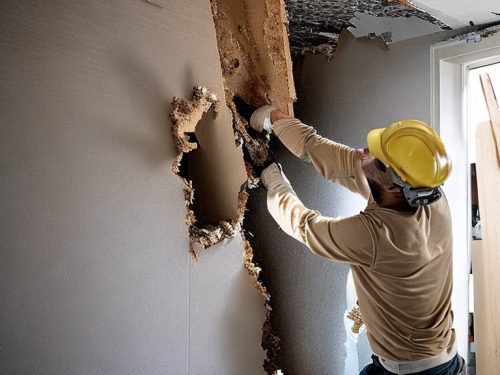 photo of a contractor undertaking selective demolition in a building